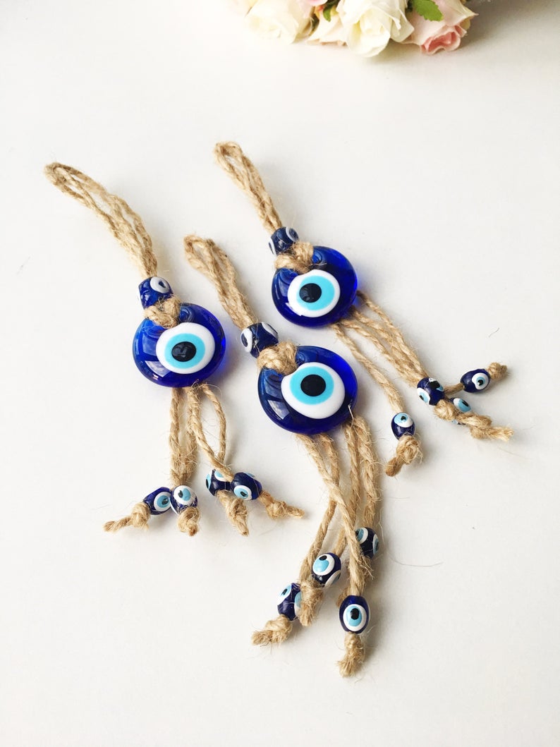 Small blue evil eye wall hanging with gold macrame, featuring a 3.5cm diameter evil eye bead, perfect for home decor and gifts.