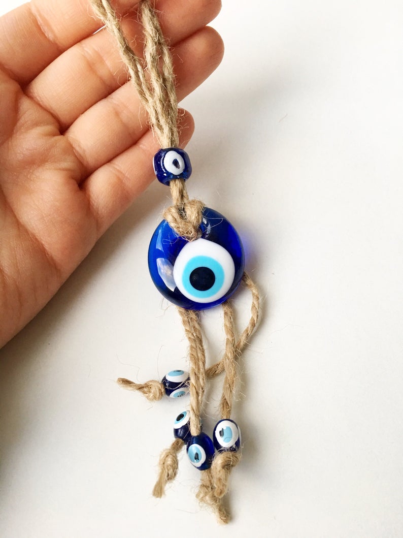 Small blue evil eye wall hanging with gold macrame, featuring a 3.5cm diameter evil eye bead, perfect for home decor and gifts.