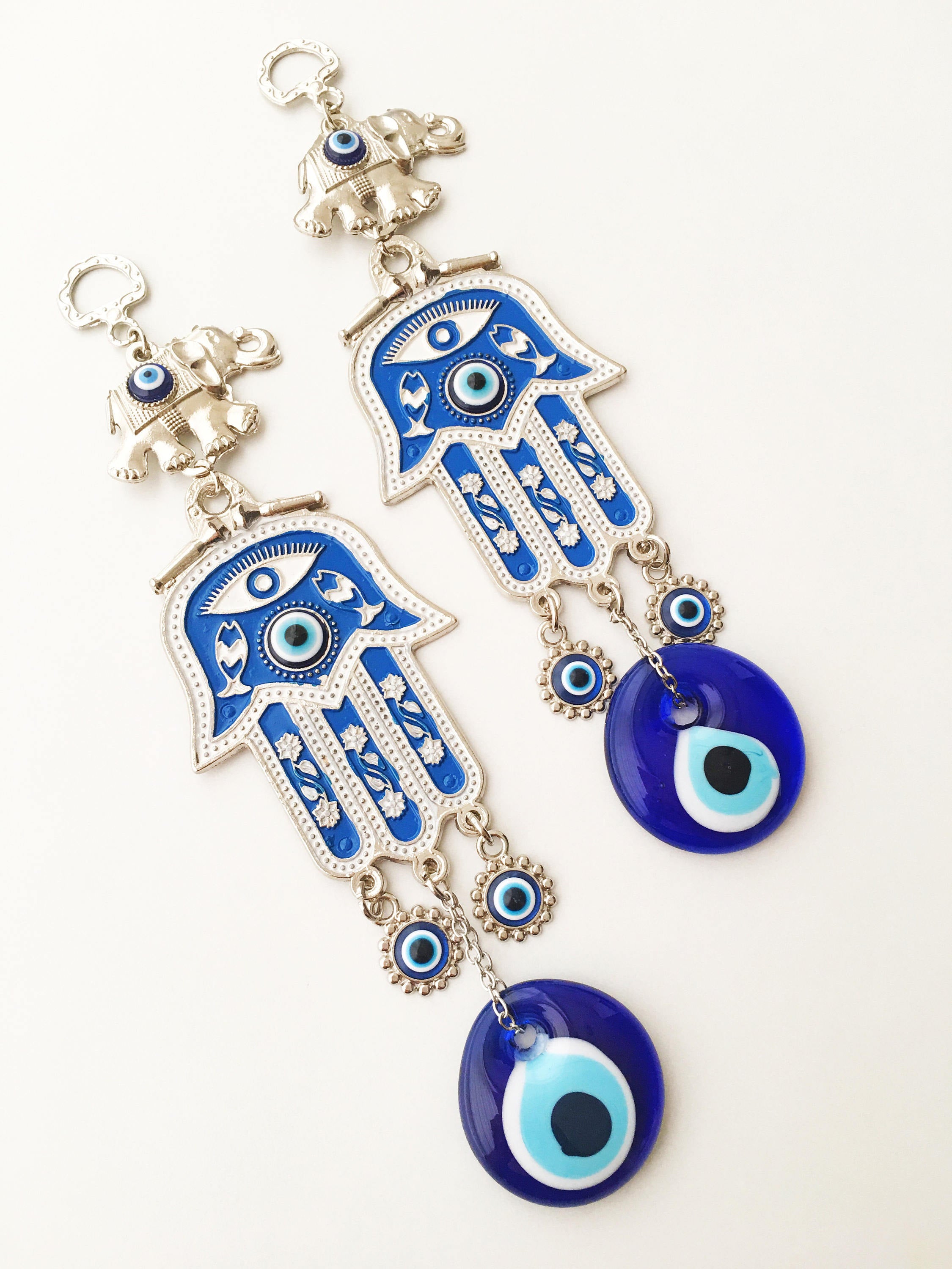 Blue Hamsa Evil Eye Wall Art featuring a mosaic metal hamsa hand and large evil eye bead, symbolizing protection and good luck.