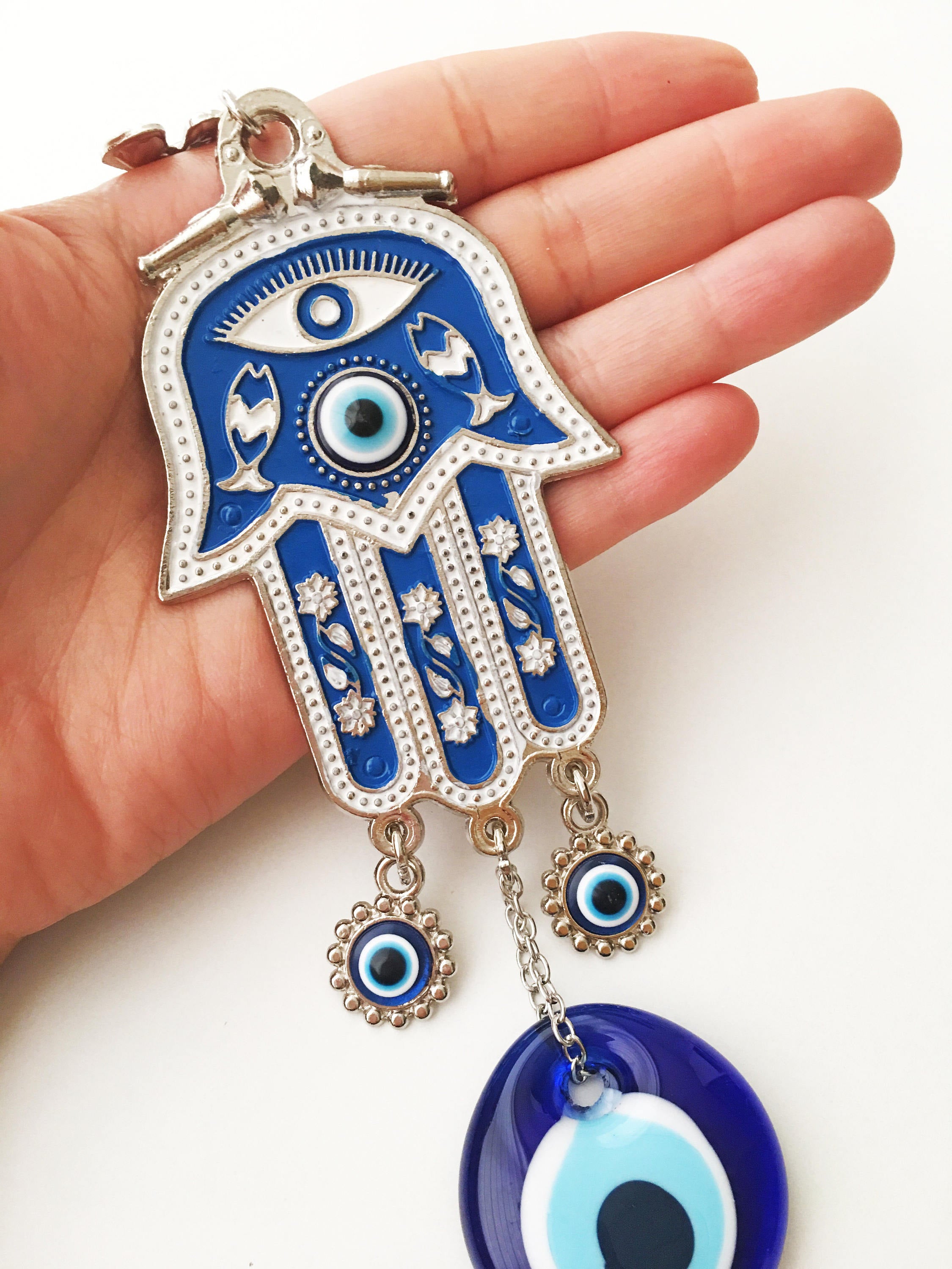 Blue Hamsa Evil Eye Wall Art featuring a mosaic metal hamsa hand and large evil eye bead, symbolizing protection and good luck.