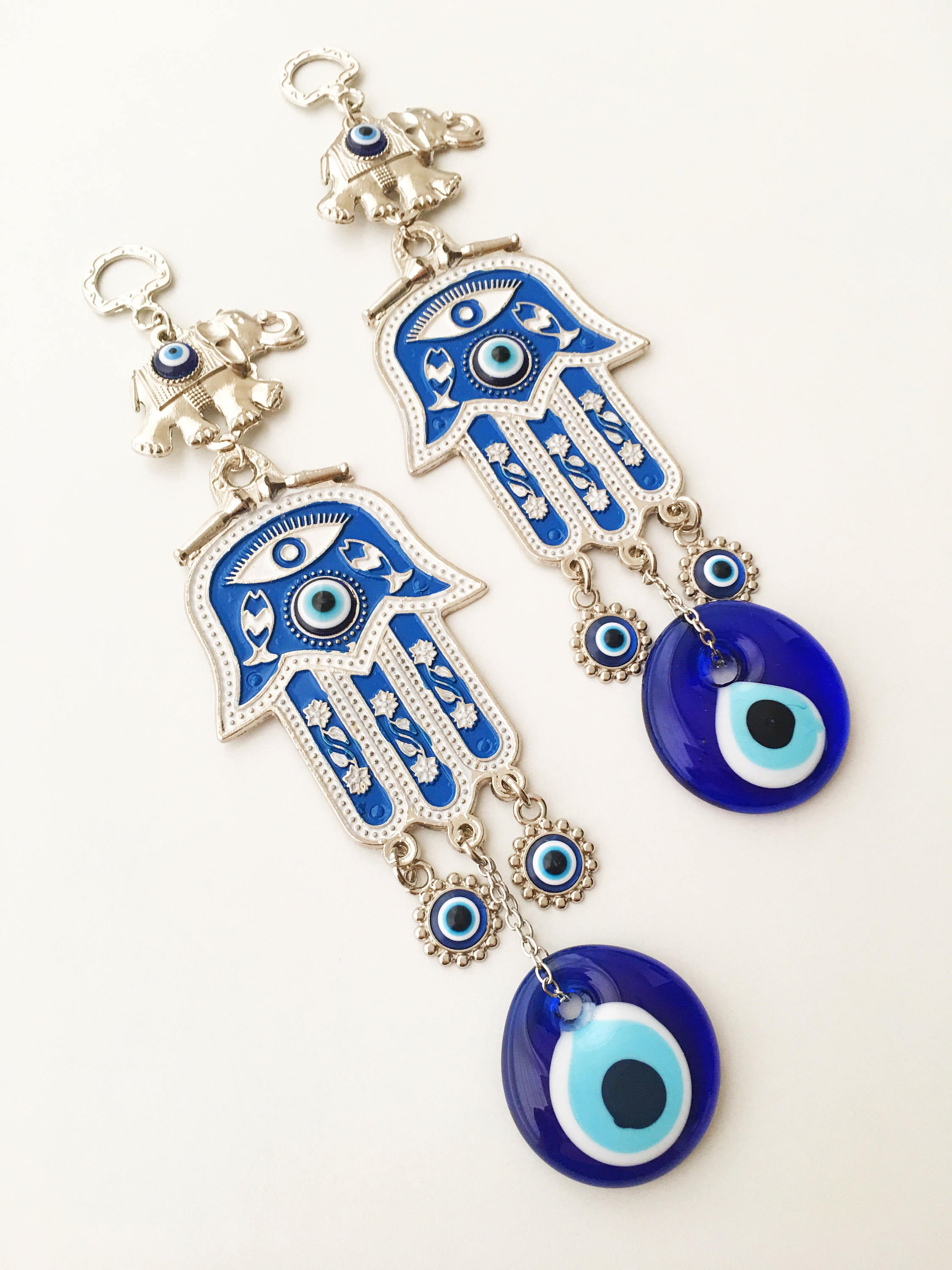 Blue Hamsa Evil Eye Wall Art featuring a mosaic metal hamsa hand and large evil eye bead, symbolizing protection and good luck.