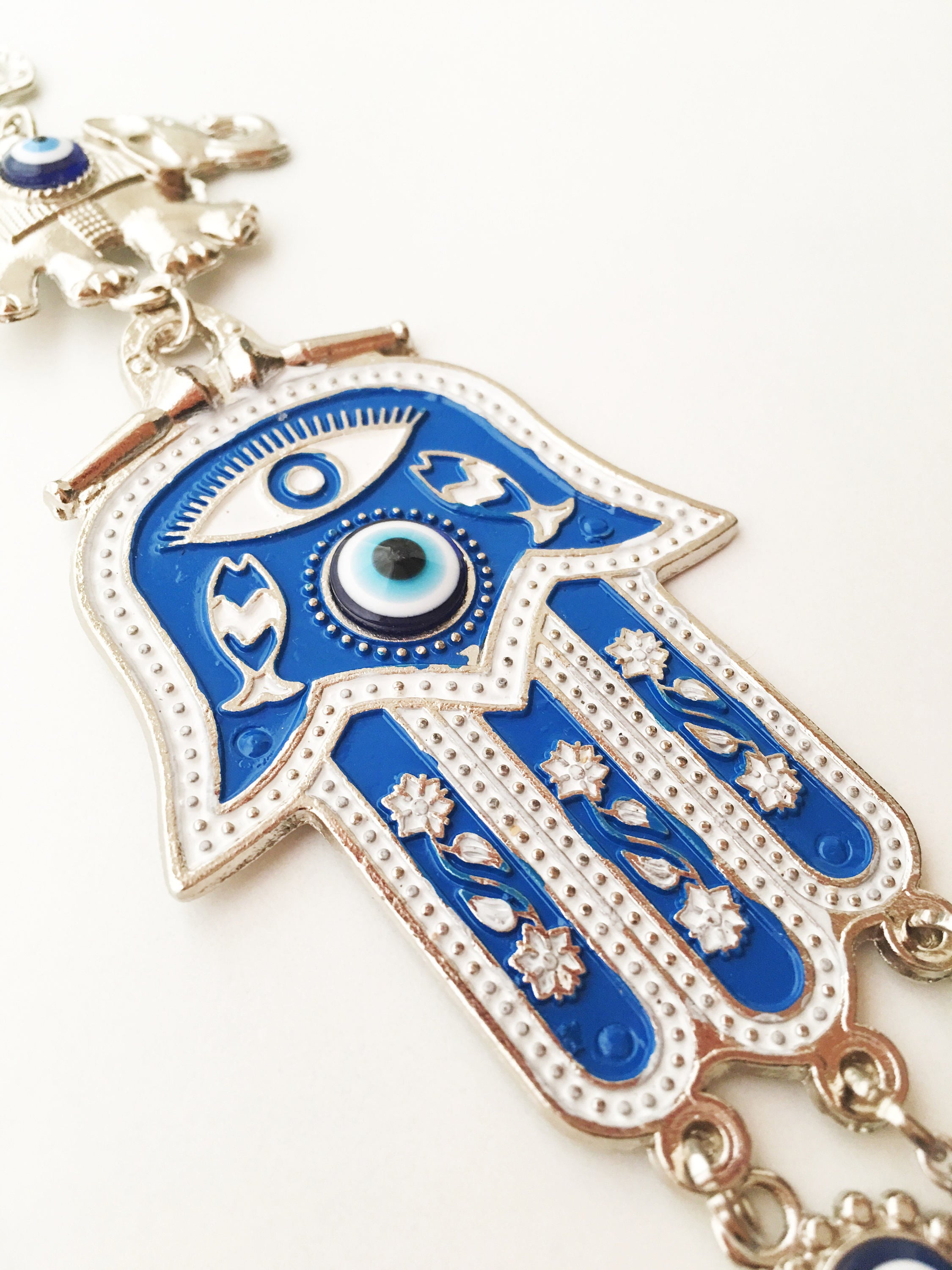 Blue Hamsa Evil Eye Wall Art featuring a mosaic metal hamsa hand and large evil eye bead, symbolizing protection and good luck.