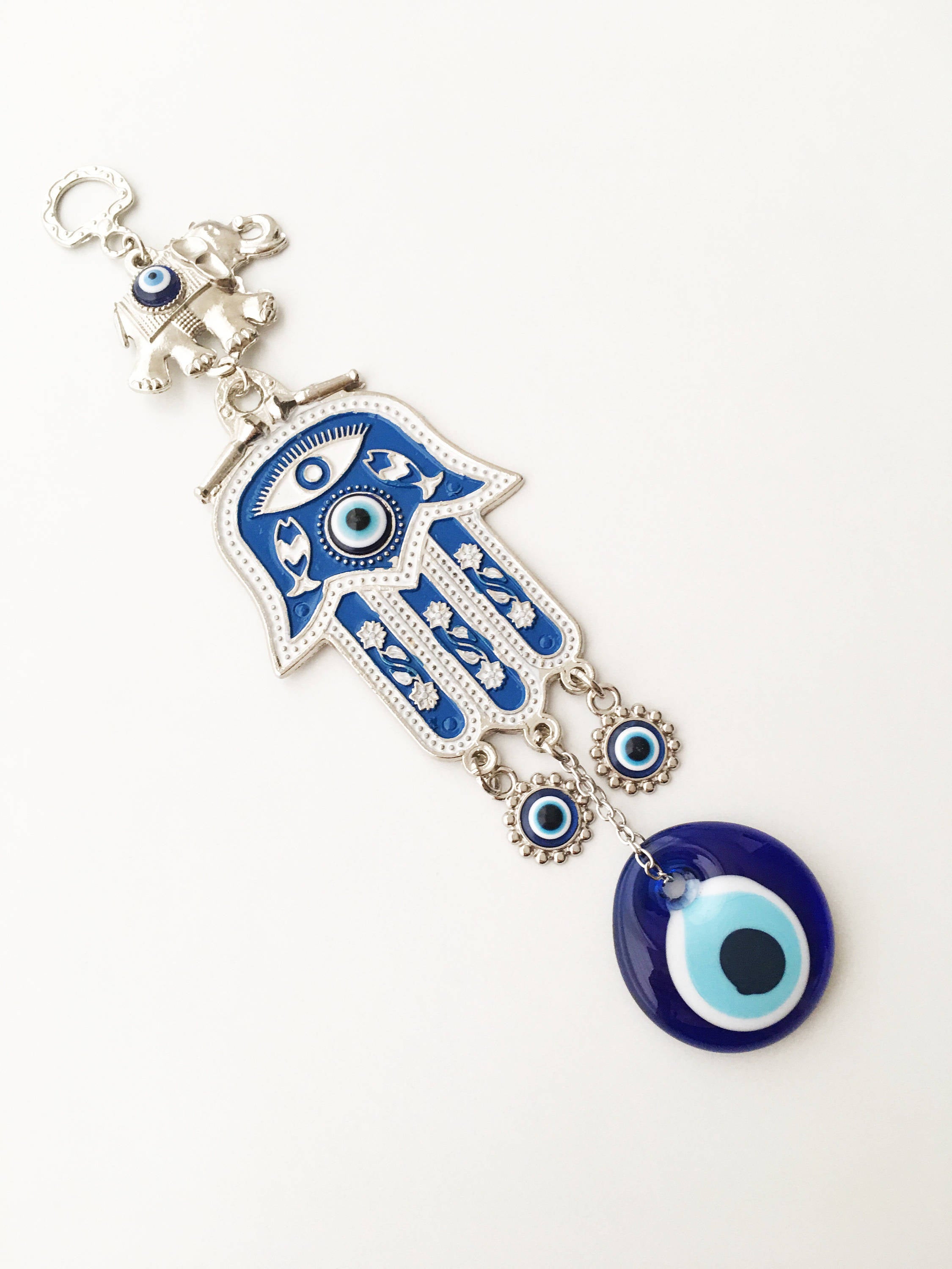 Blue Hamsa Evil Eye Wall Art featuring a mosaic metal hamsa hand and large evil eye bead, symbolizing protection and good luck.