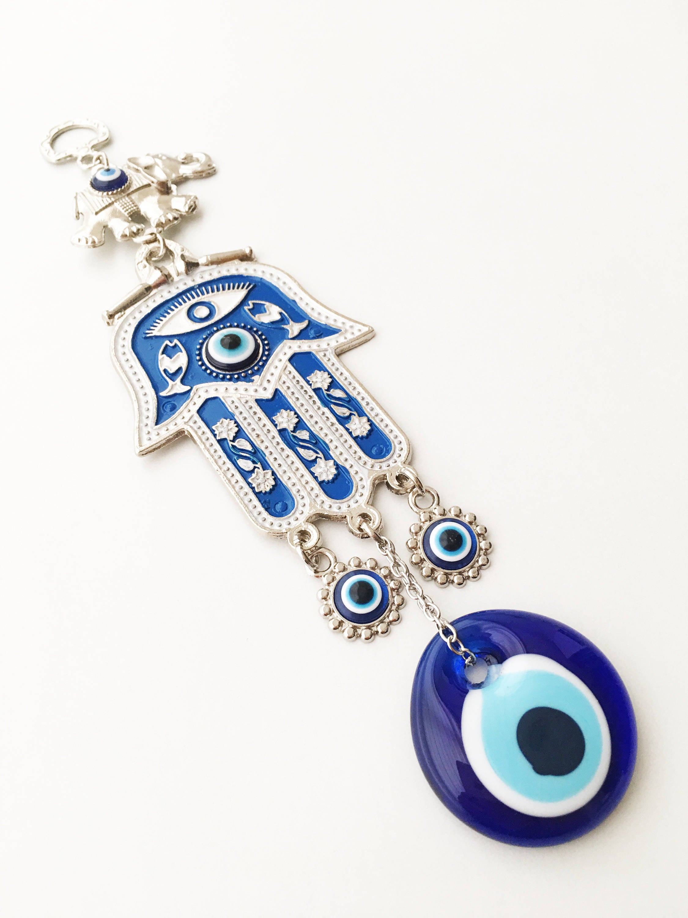 Blue Hamsa Evil Eye Wall Art featuring a mosaic metal hamsa hand and large evil eye bead, symbolizing protection and good luck.