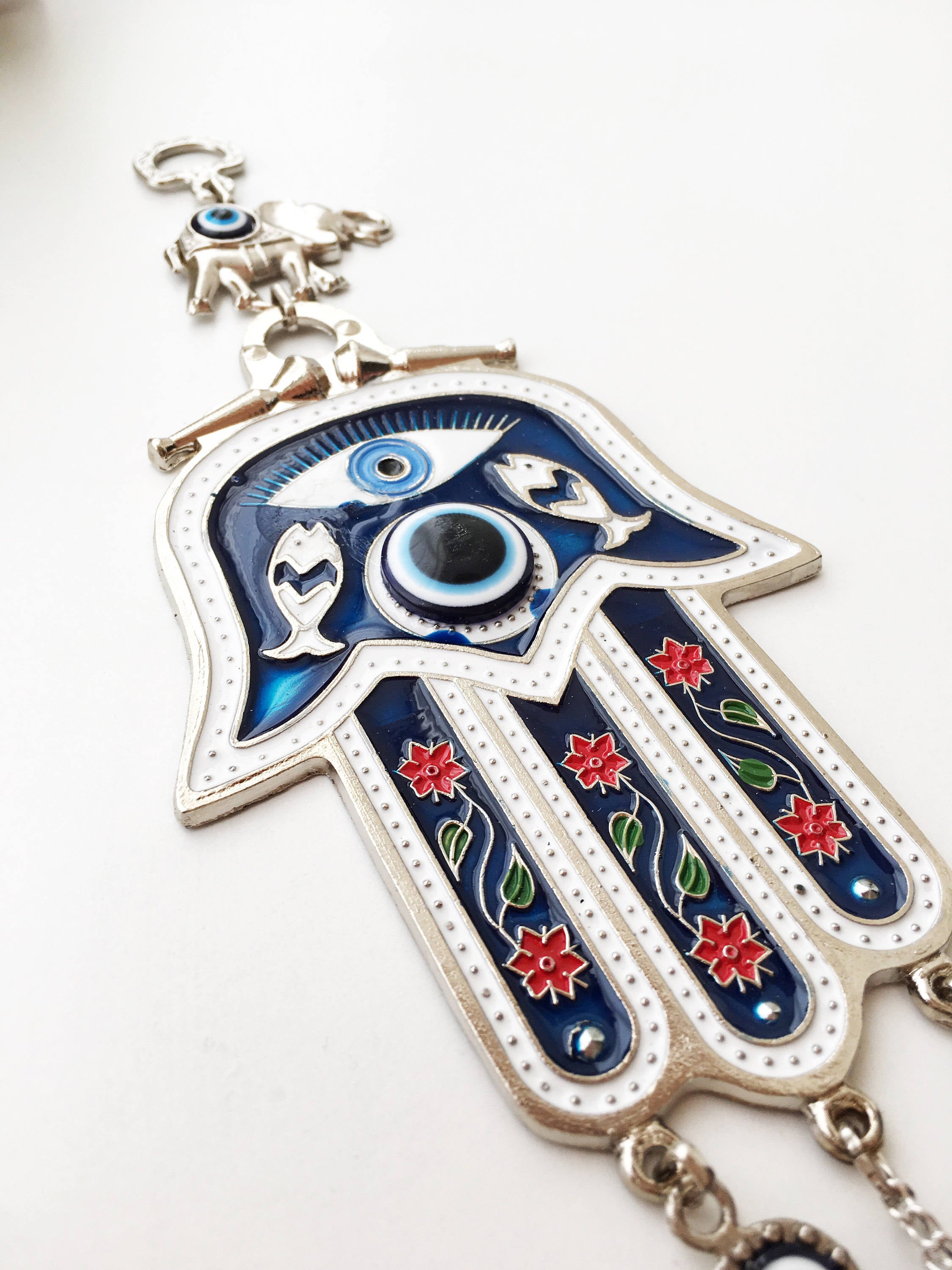 Blue Hamsa Hand Wall Decor featuring a large evil eye bead, intricately designed with mosaic metal.