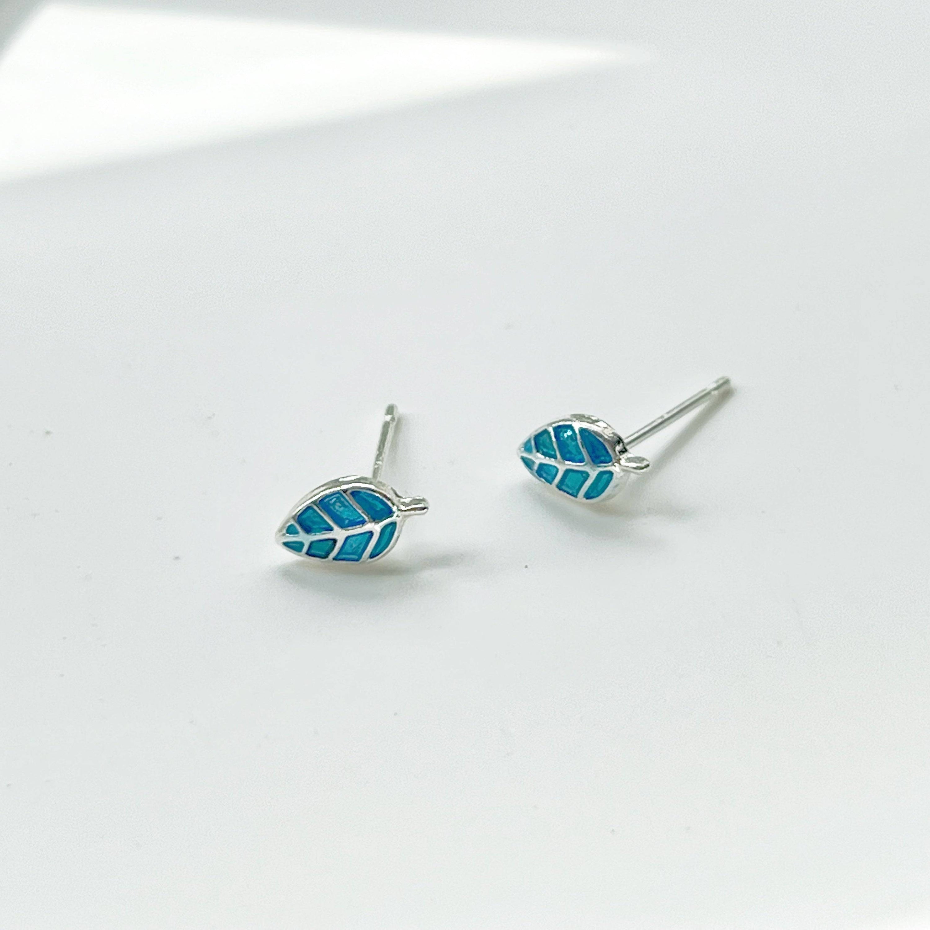 A pair of elegant blue leaves silver stud earrings, featuring a delicate design with sterling silver studs and a silver-plated bronze base.