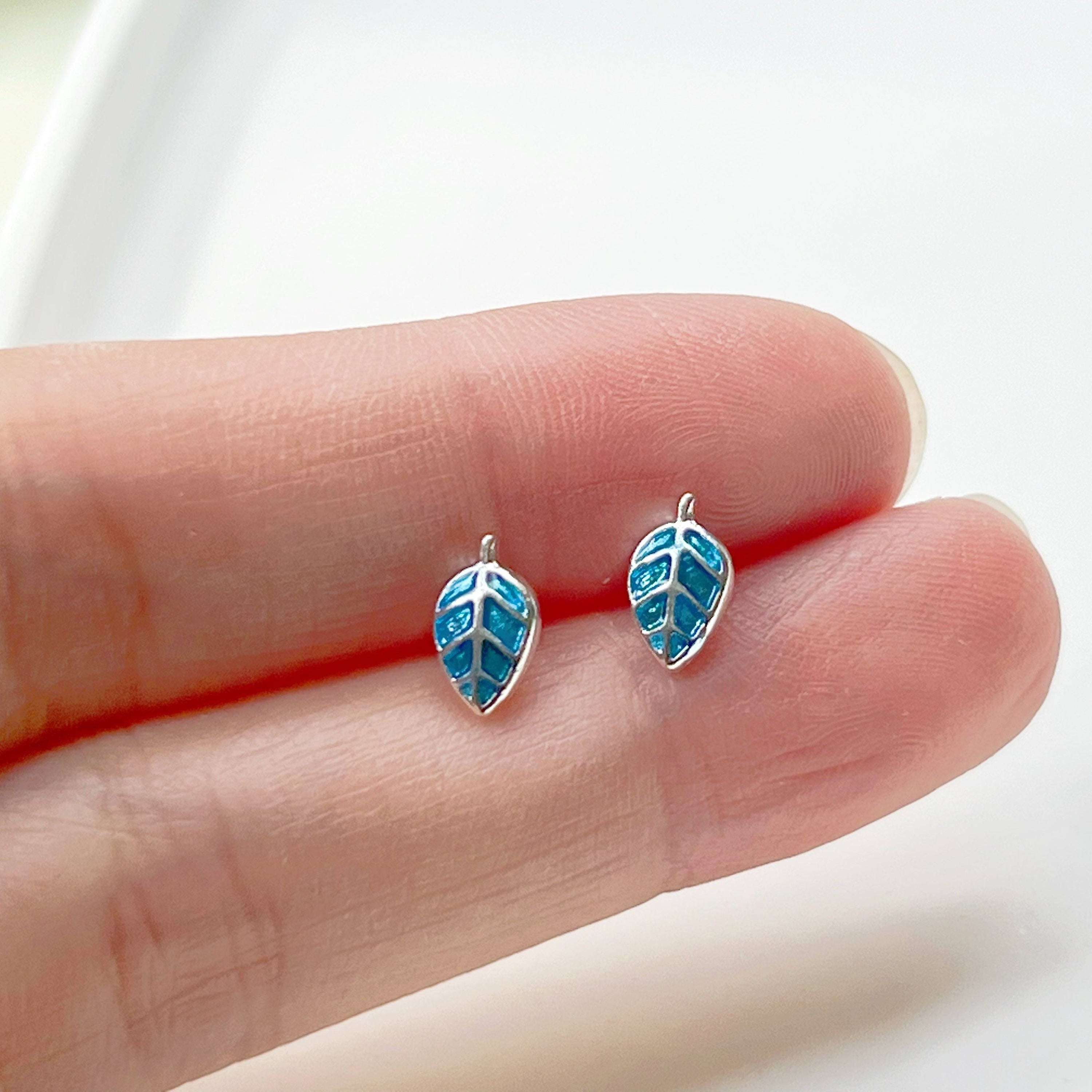 A pair of elegant blue leaves silver stud earrings, featuring a delicate design with sterling silver studs and a silver-plated bronze base.