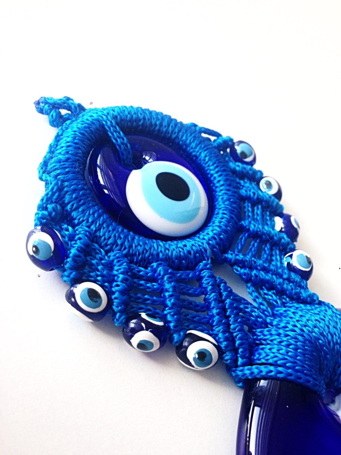 Handmade Blue Macrame Wall Hanging featuring a large and small evil eye charm, showcasing intricate knotting and vibrant blue colors.