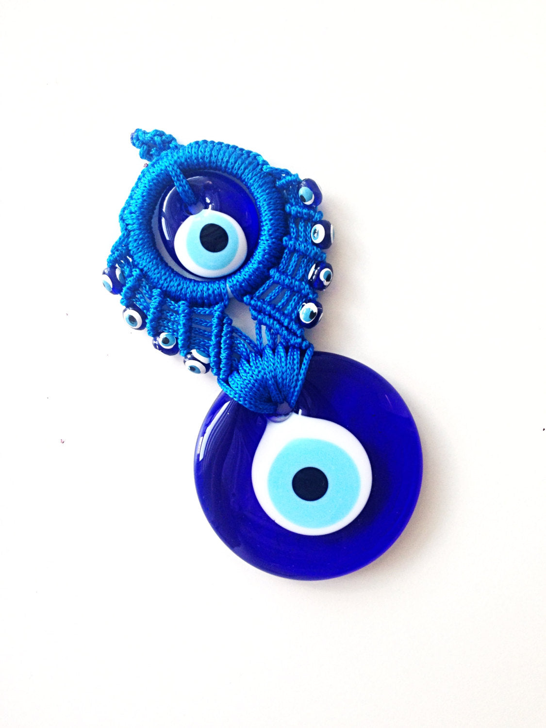 Handmade Blue Macrame Wall Hanging featuring a large and small evil eye charm, showcasing intricate knotting and vibrant blue colors.