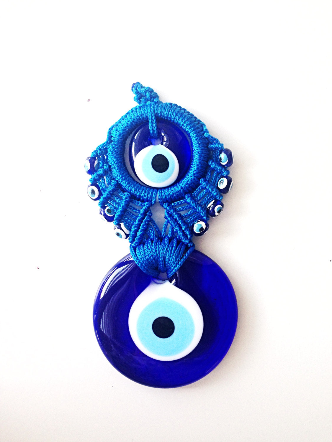 Handmade Blue Macrame Wall Hanging featuring a large and small evil eye charm, showcasing intricate knotting and vibrant blue colors.