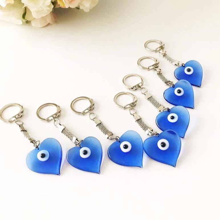 A beautiful blue Murano glass evil eye keychain featuring a heart design, symbolizing protection and luck.