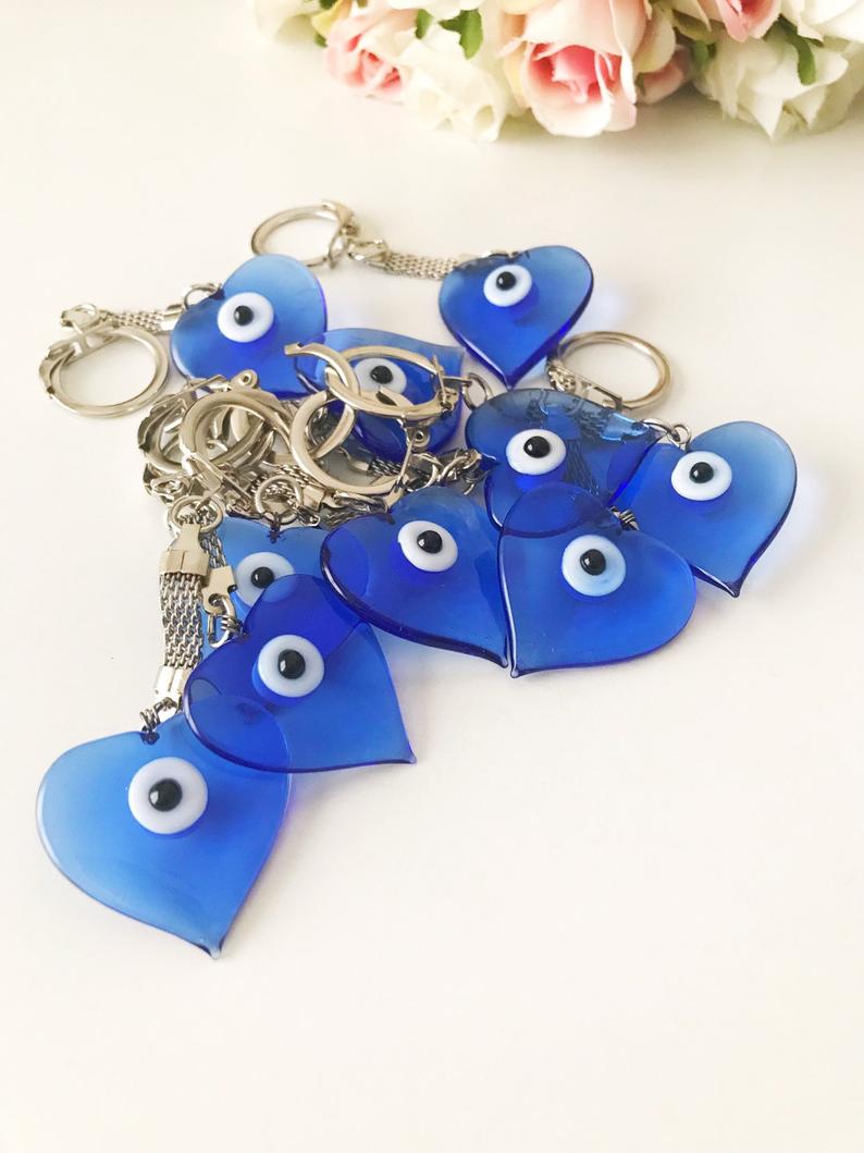 A beautiful blue Murano glass evil eye keychain featuring a heart design, symbolizing protection and luck.