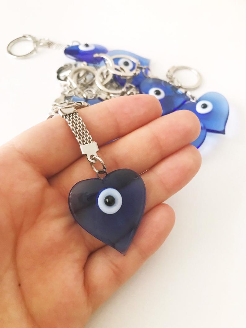 A beautiful blue Murano glass evil eye keychain featuring a heart design, symbolizing protection and luck.