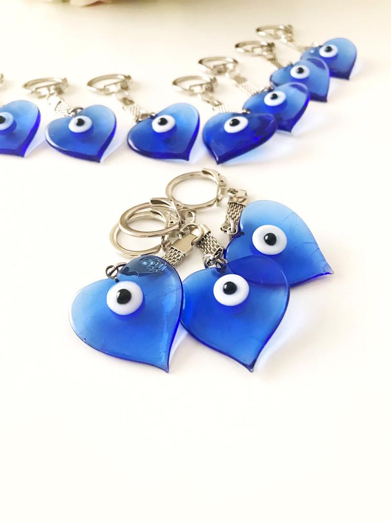 A beautiful blue Murano glass evil eye keychain featuring a heart design, symbolizing protection and luck.