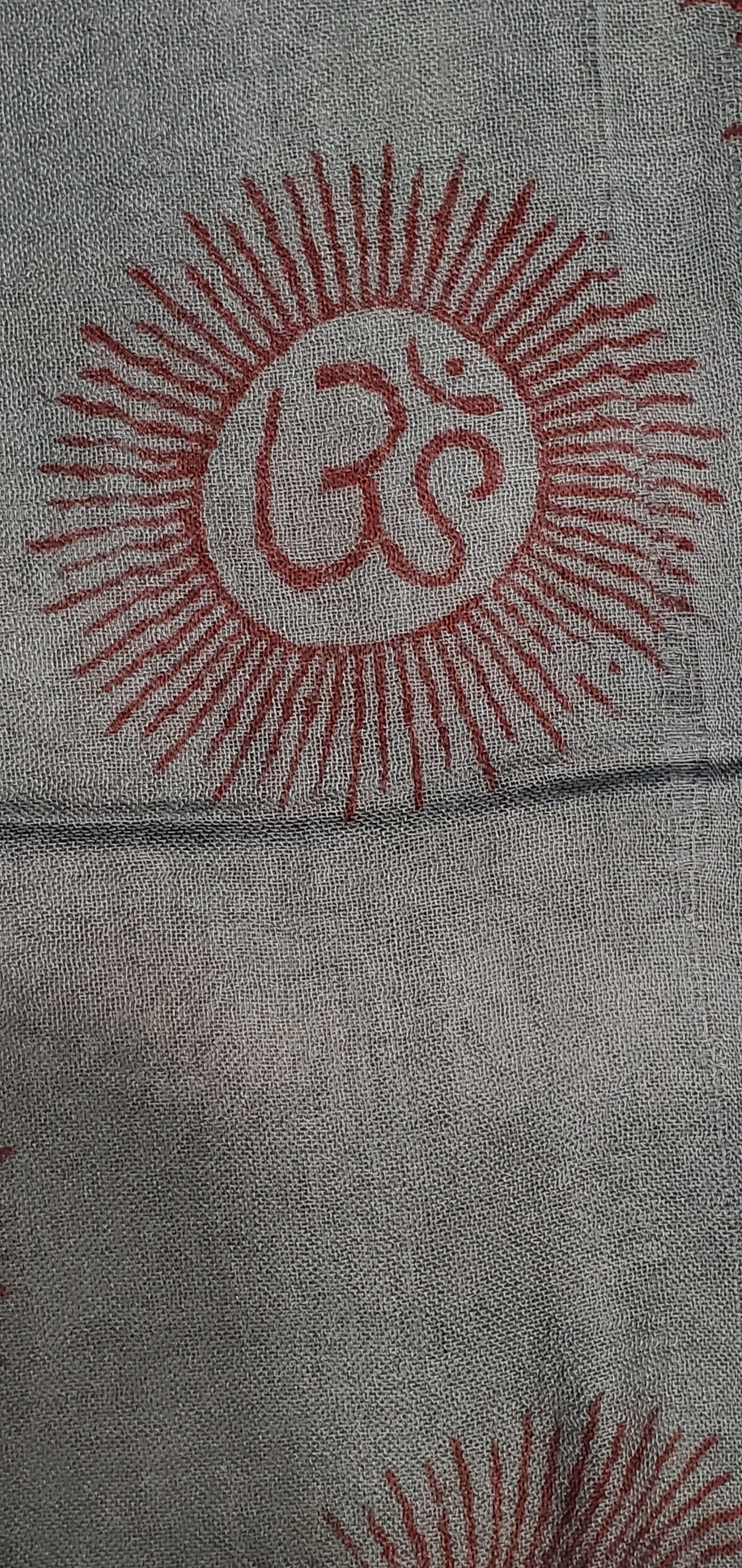 A vibrant blue scarf featuring intricate Om and Asian symbols in red-orange, made from 100% cotton, perfect for meditation and traditional wear.