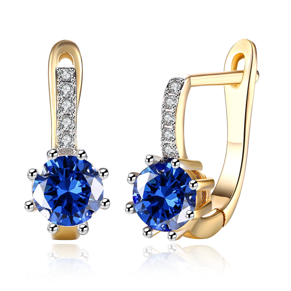 Elegant Blue Topaz 0.70 CT Round Huggie Earring in 18K White Gold Plated, showcasing a vibrant blue gemstone and luxurious finish.