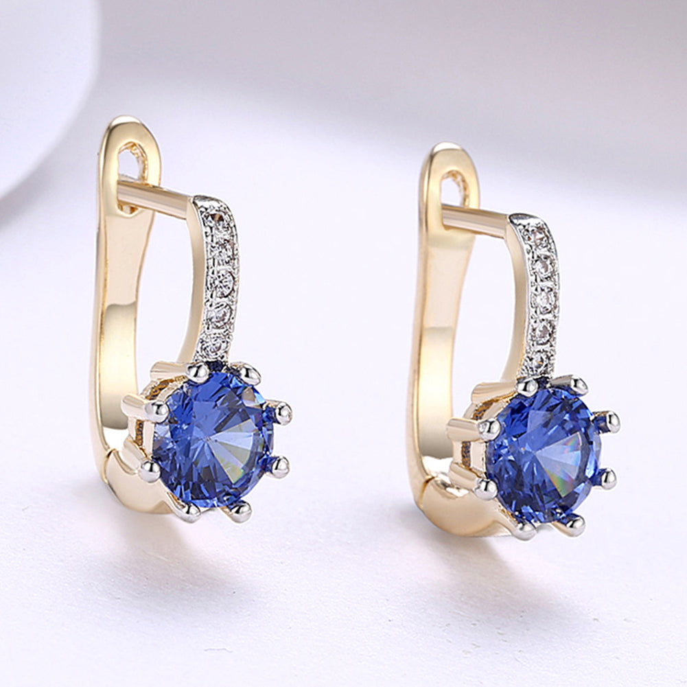 Elegant Blue Topaz 0.70 CT Round Huggie Earring in 18K White Gold Plated, showcasing a vibrant blue gemstone and luxurious finish.