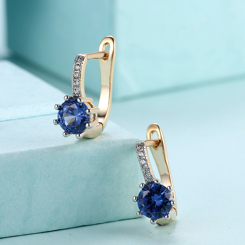 Elegant Blue Topaz 0.70 CT Round Huggie Earring in 18K White Gold Plated, showcasing a vibrant blue gemstone and luxurious finish.