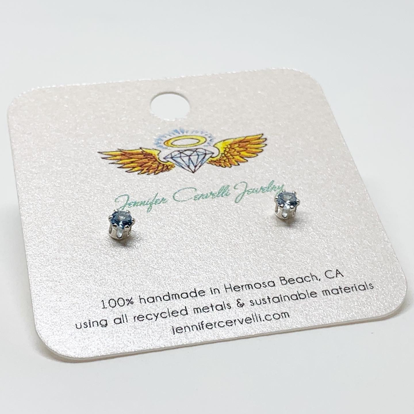 A pair of stunning blue zircon birthstone earrings featuring 3mm round faceted gemstones set in a 6 prong stud design, available in sterling silver or yellow gold fill.