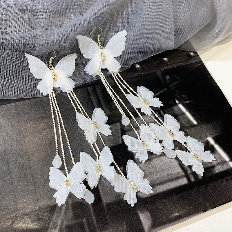 Elegant Bohemia Lace Butterfly Earrings with Triple Pearl Tassels, showcasing intricate lace design and sparkling rhinestones.