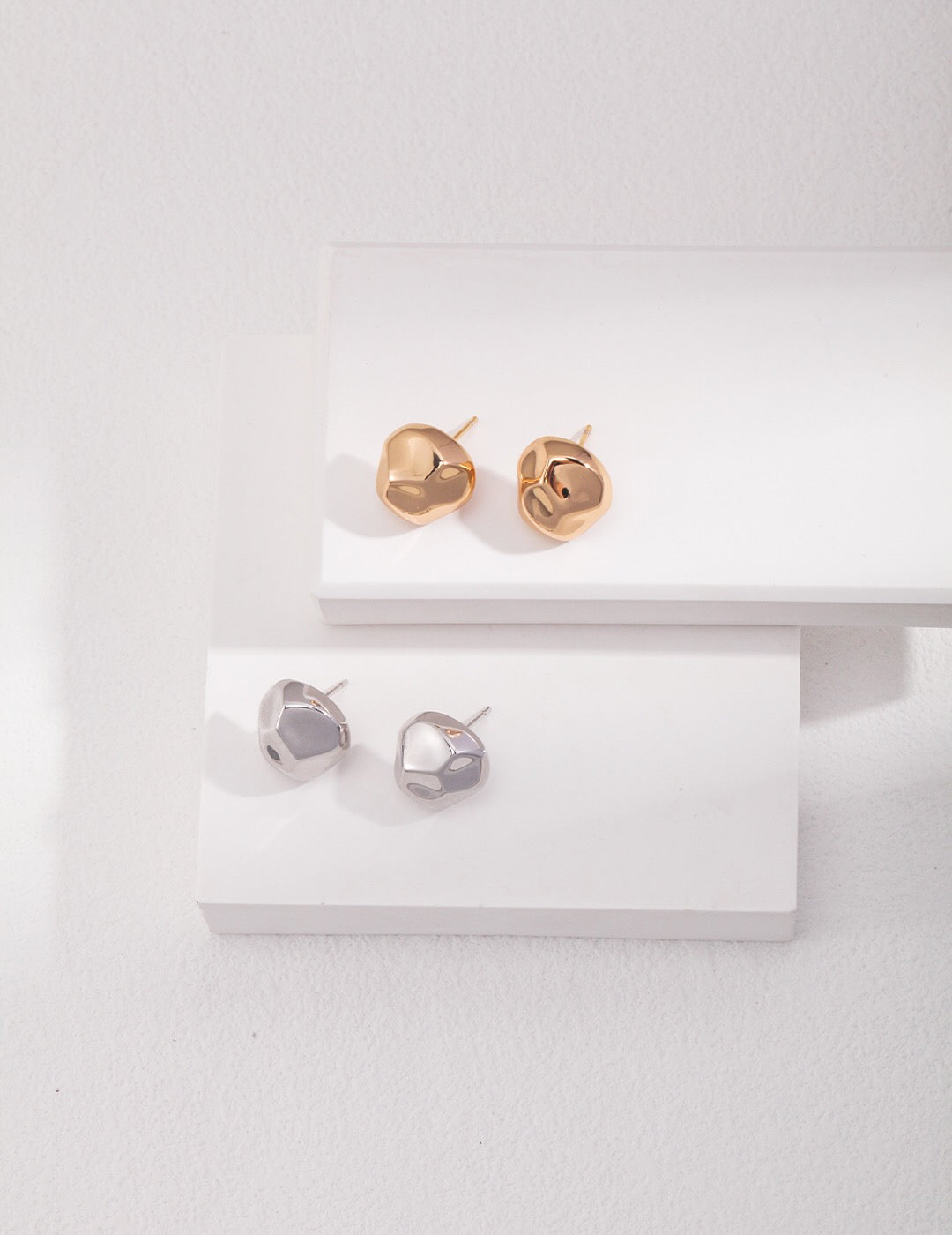 A pair of elegant Bold Geometric Stud Earrings made from sterling silver and gold vermeil, showcasing a modern geometric design.