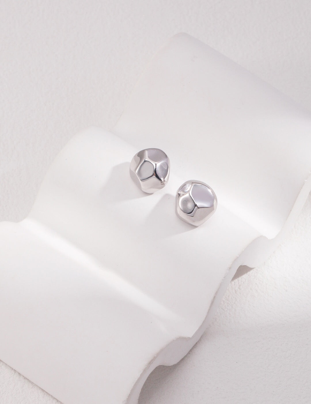 A pair of elegant Bold Geometric Stud Earrings made from sterling silver and gold vermeil, showcasing a modern geometric design.