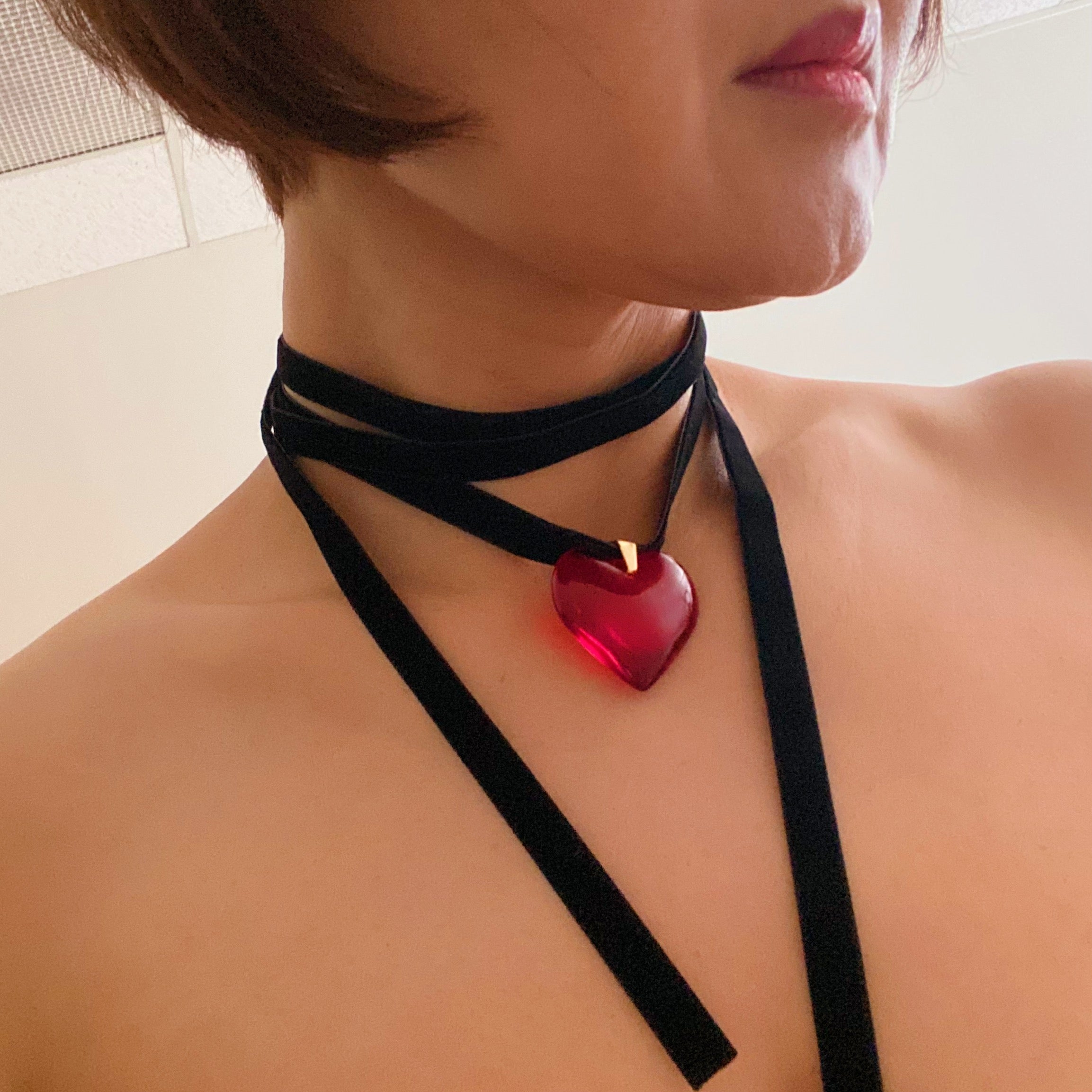 Bold In Red Black Sash Necklace featuring a red heart pendant and a black velvet sash, elegantly displayed on a neutral background.