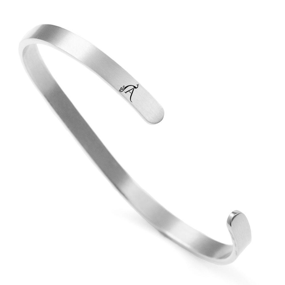 A dainty stainless steel cuff bracelet with the word 'Bonheur' engraved, symbolizing happiness and French inspiration.