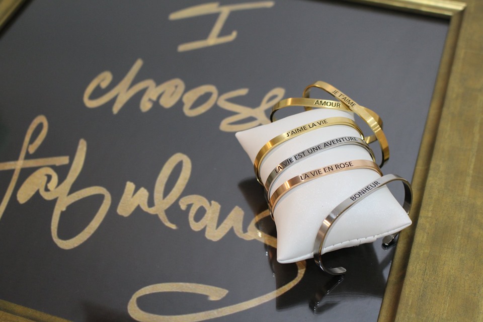 A dainty stainless steel cuff bracelet with the word 'Bonheur' engraved, symbolizing happiness and French inspiration.