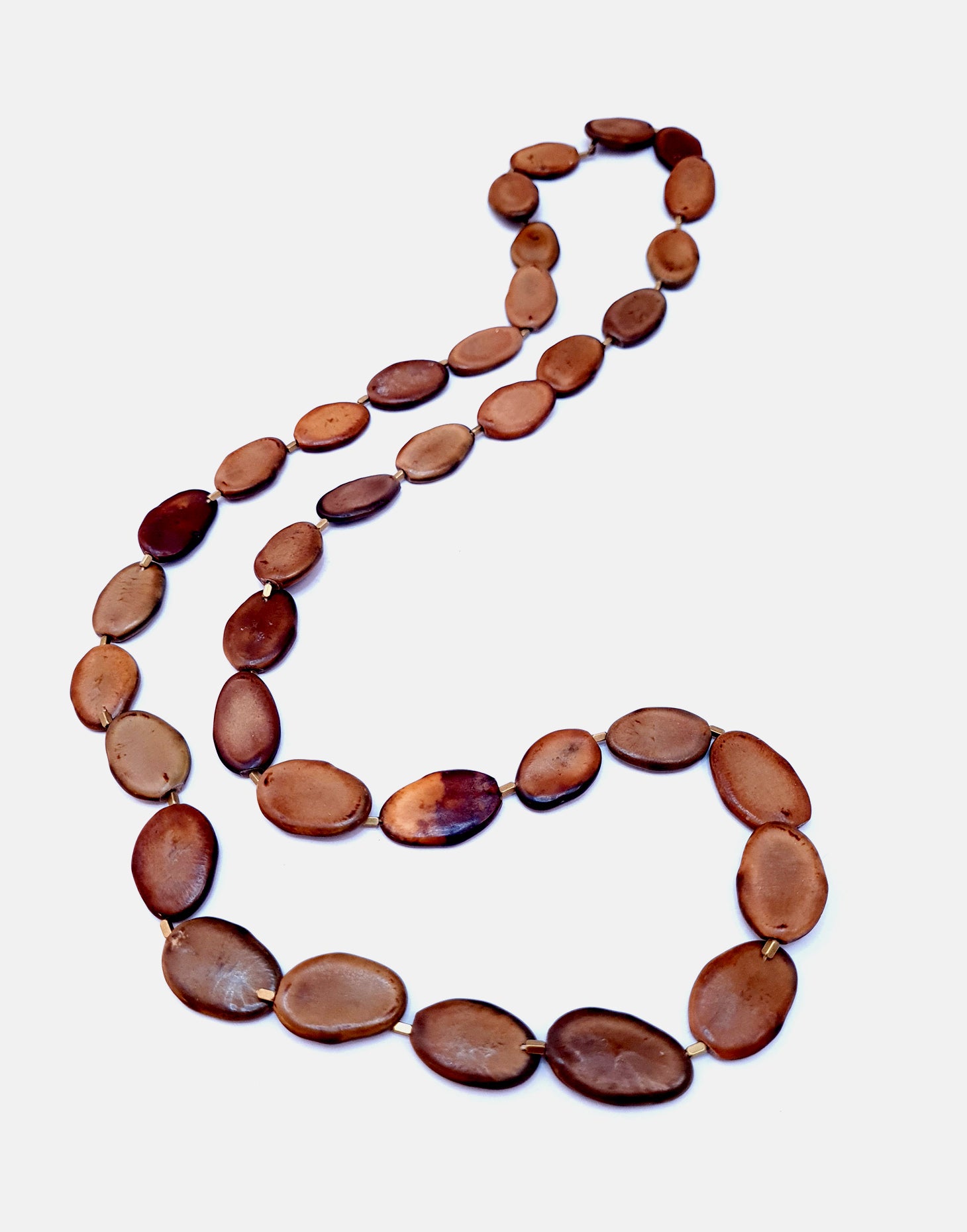 Botanic Necklace made from Guapuruvu seed, featuring raw brass findings, showcasing its unique eco-friendly design.