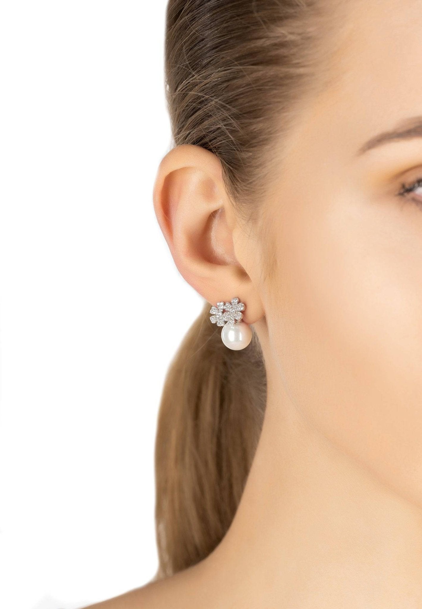 Elegant silver bouquet and pearl stud earrings featuring floral design and sparkling cubic zirconia.