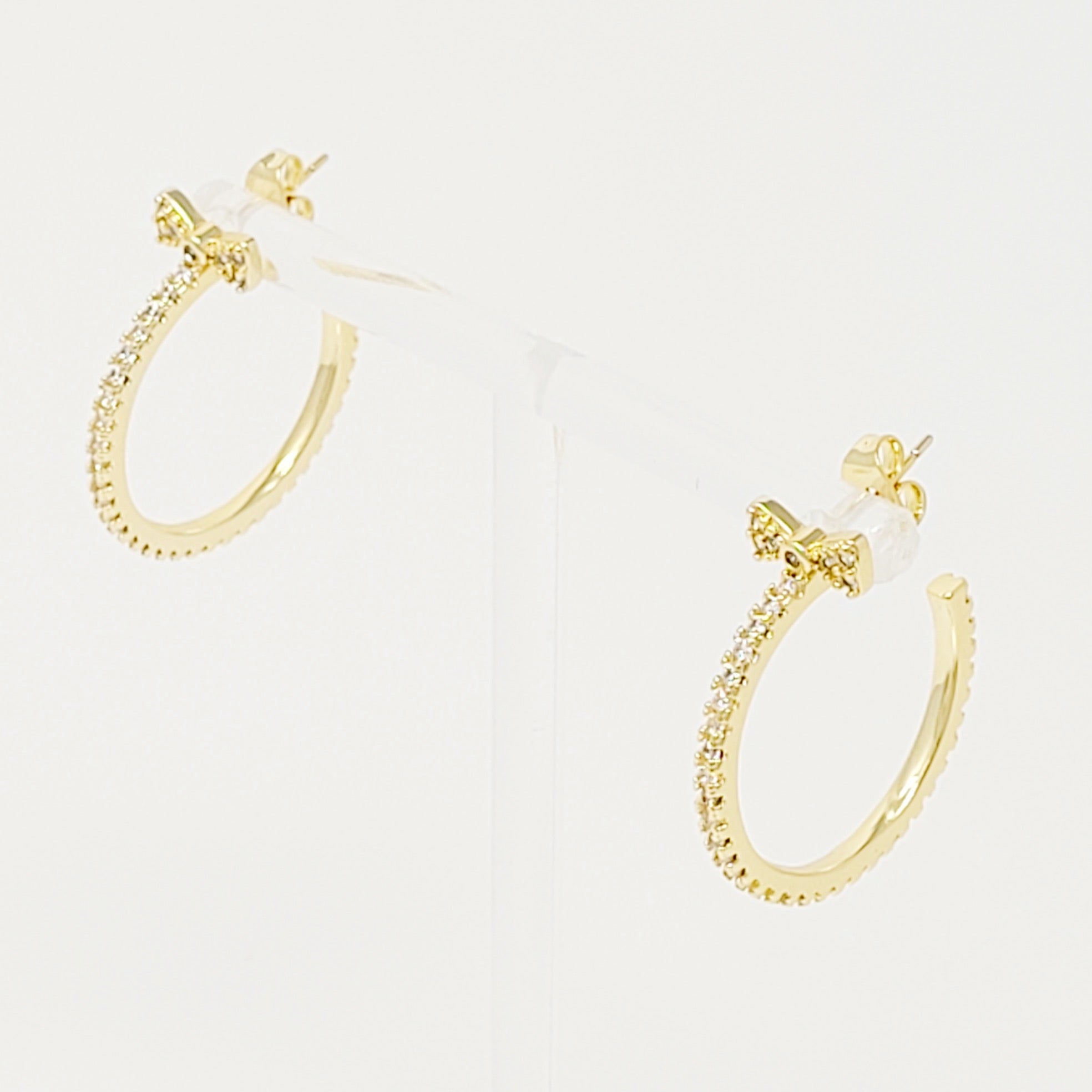 Elegant Bow On Top Hoop Earrings with shiny cubic zirconia, 18K gold plated brass, showcasing a chic design.