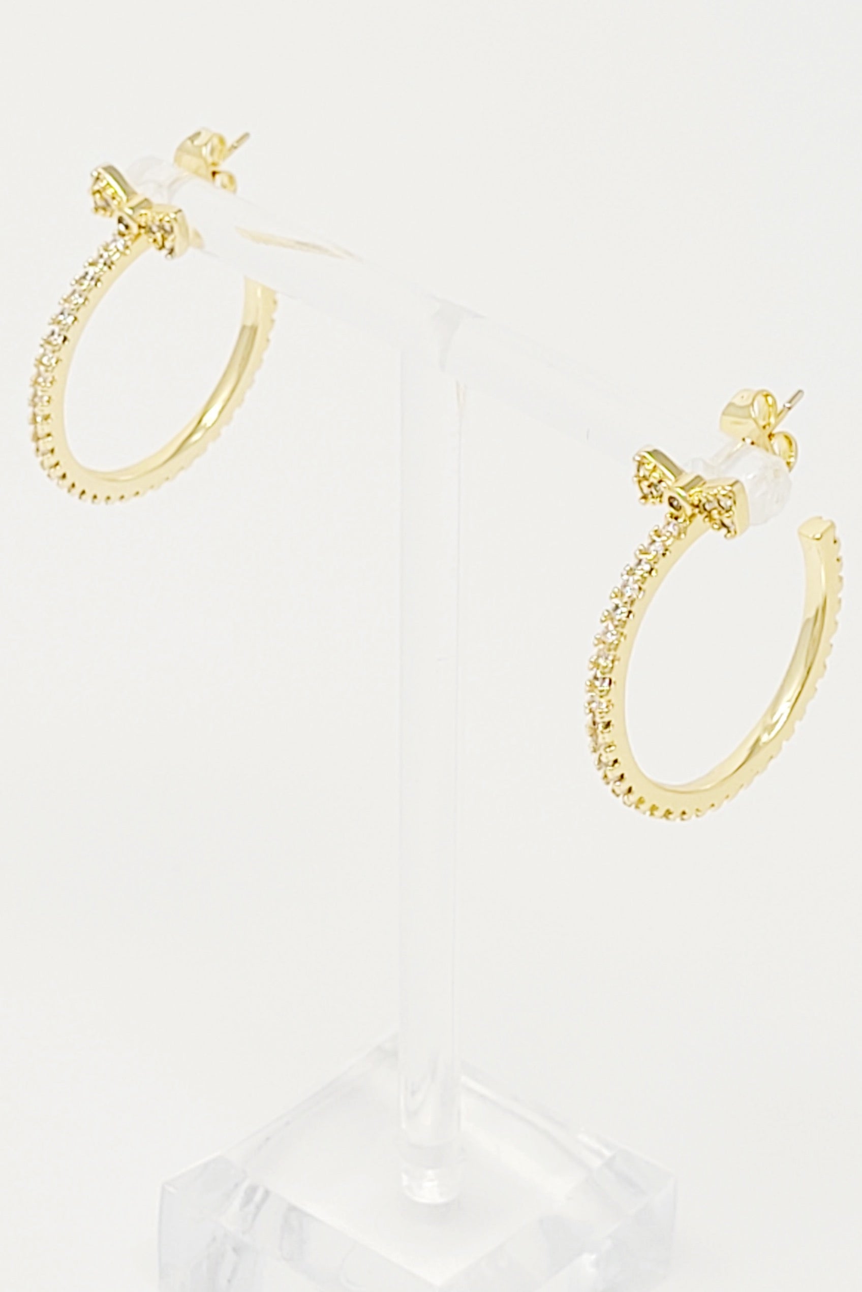 Elegant Bow On Top Hoop Earrings with shiny cubic zirconia, 18K gold plated brass, showcasing a chic design.