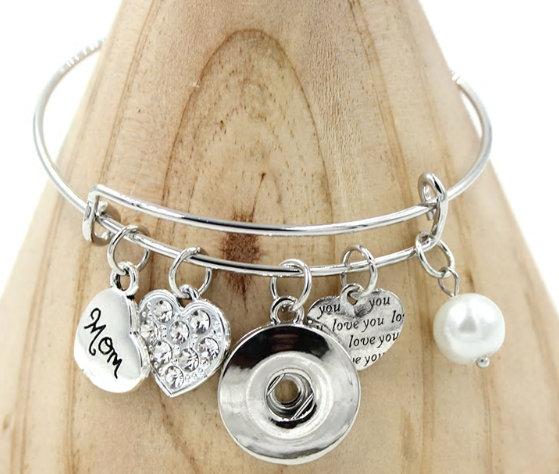 A beautifully crafted themed bangle bracelet featuring charms representing family love, made of brass and zinc alloy.