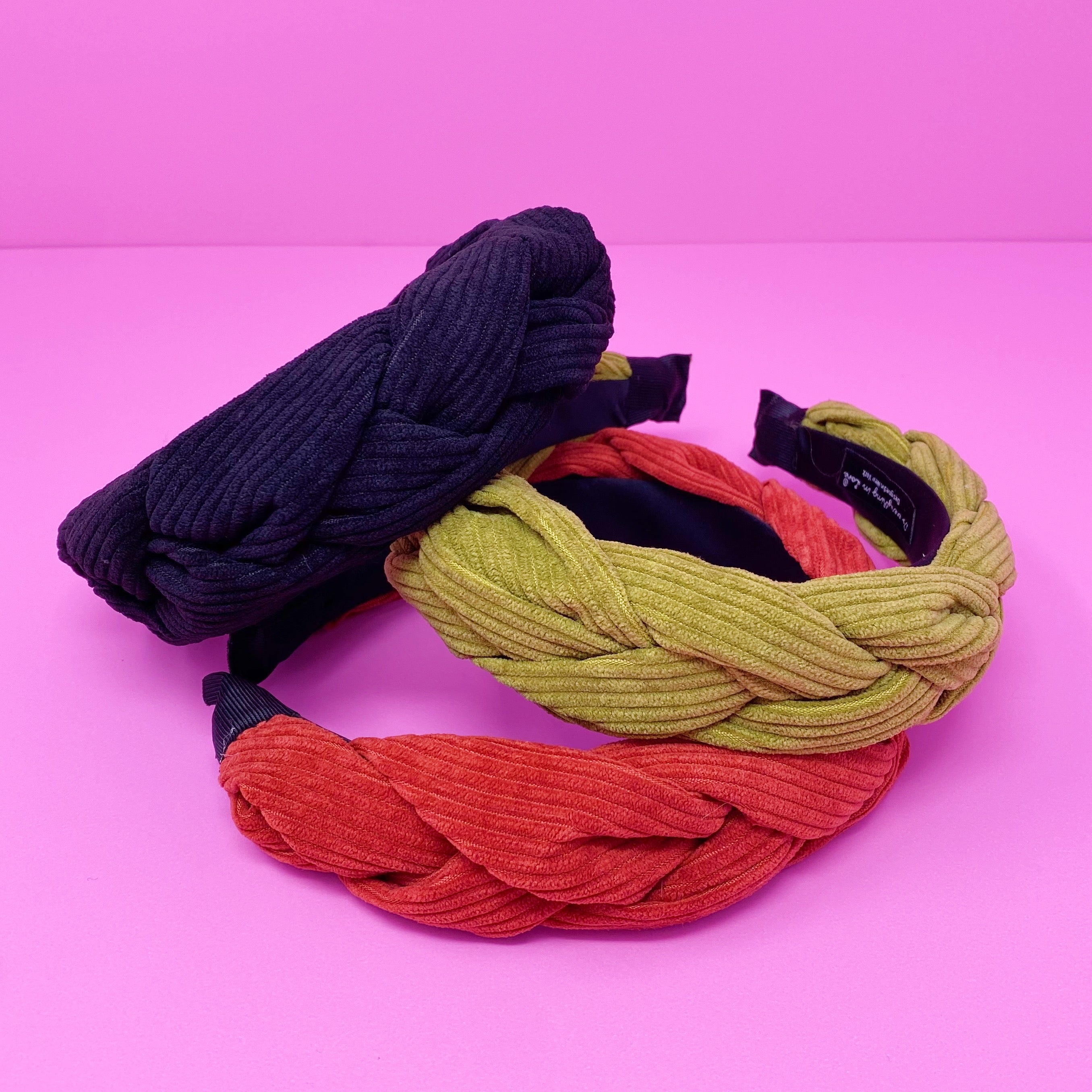 A stylish braided corduroy headband with soft edges, perfect for comfortable wear.