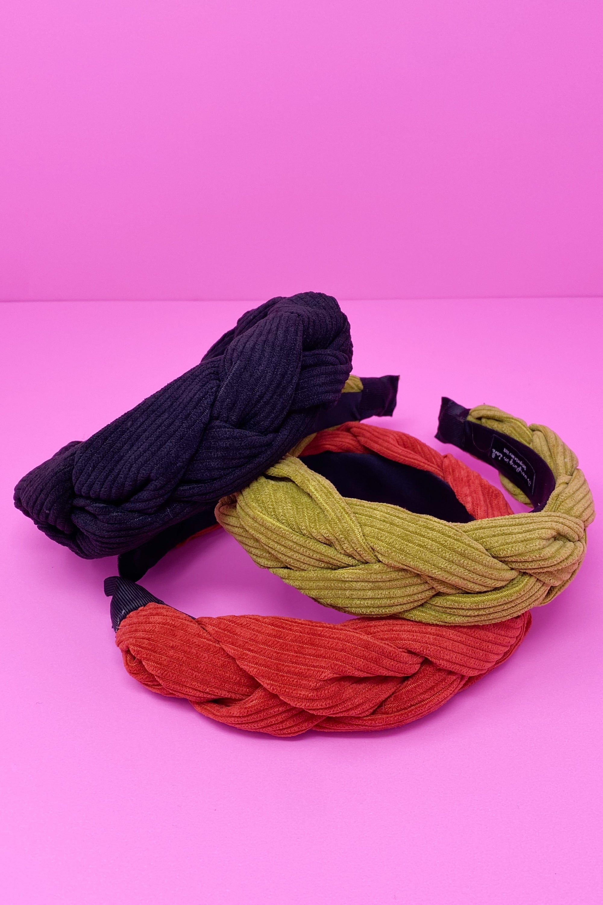 A stylish braided corduroy headband with soft edges, perfect for comfortable wear.