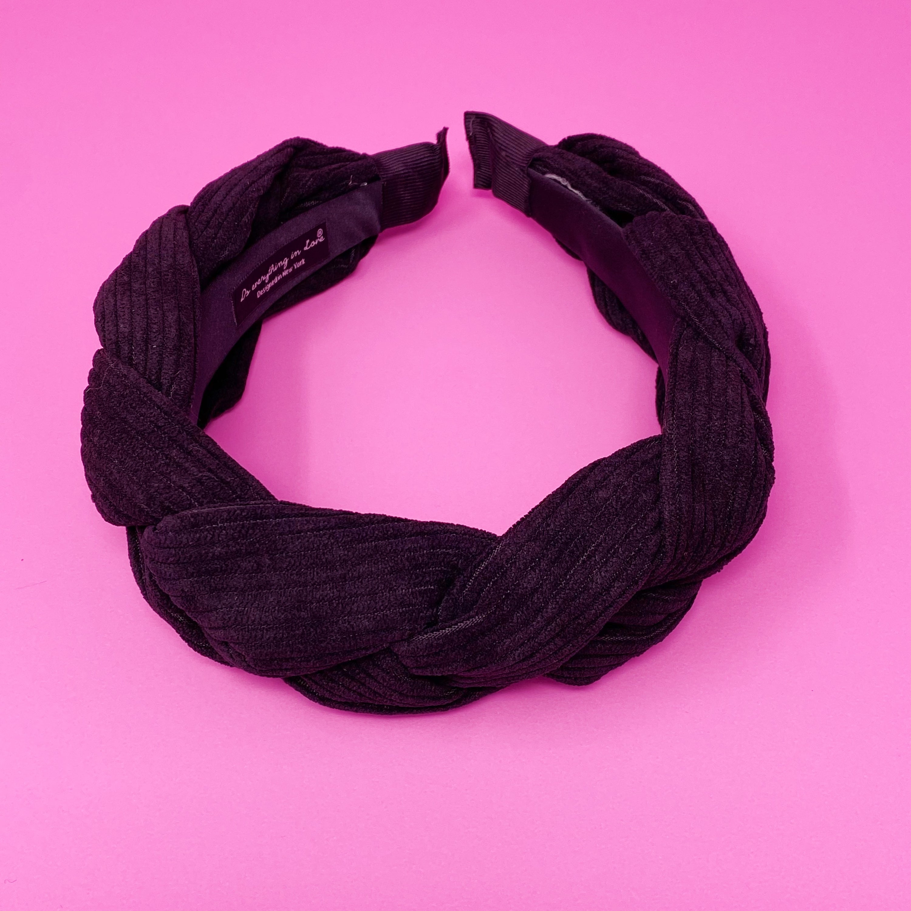 A stylish braided corduroy headband with soft edges, perfect for comfortable wear.