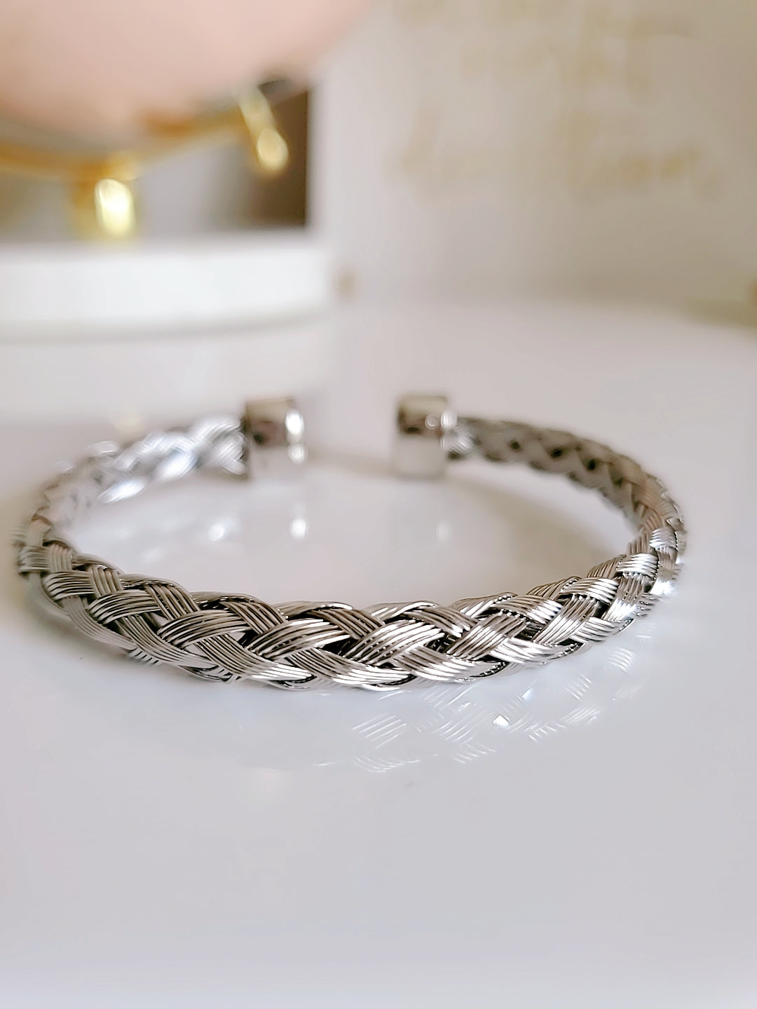 Elegant Braided Silver Cable Bangle Bracelet made of stainless steel and gold filled, showcasing intricate braided design.