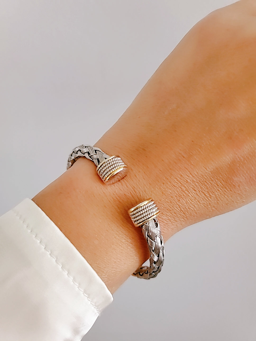 Elegant Braided Silver Cable Bangle Bracelet made of stainless steel and gold filled, showcasing intricate braided design.