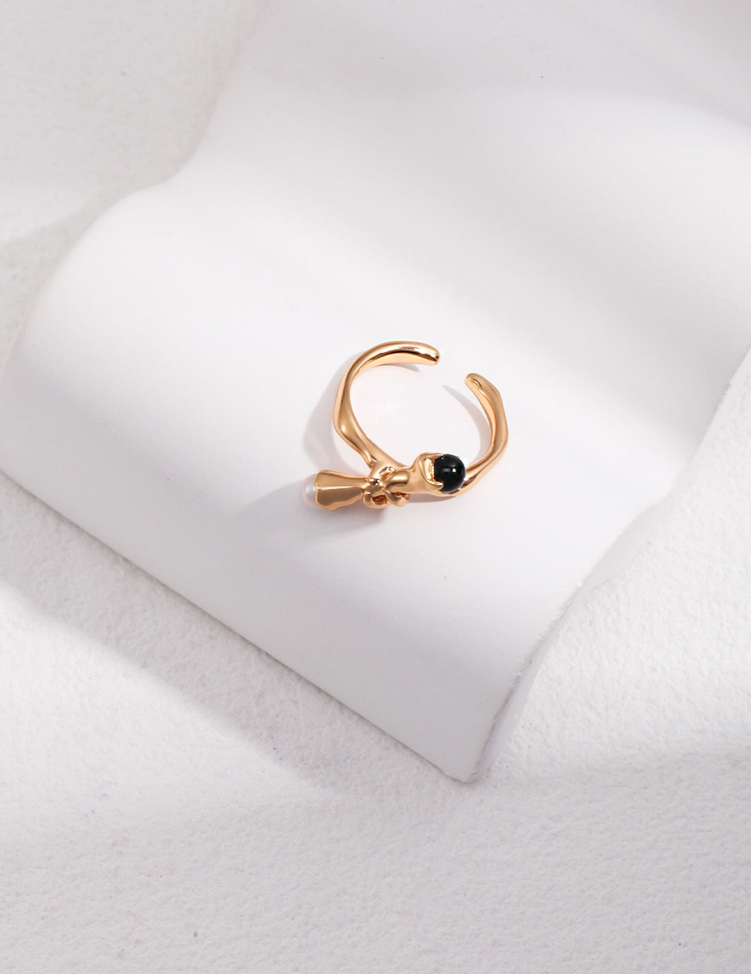 A stunning branch-shaped open ring featuring black onyx and natural pearl, elegantly designed and handcrafted.