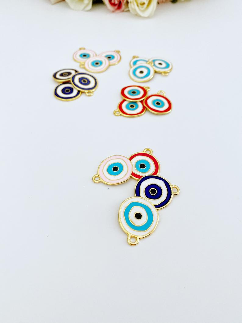 A detailed view of a brass evil eye charm featuring a vibrant blue design, perfect for DIY jewelry projects.