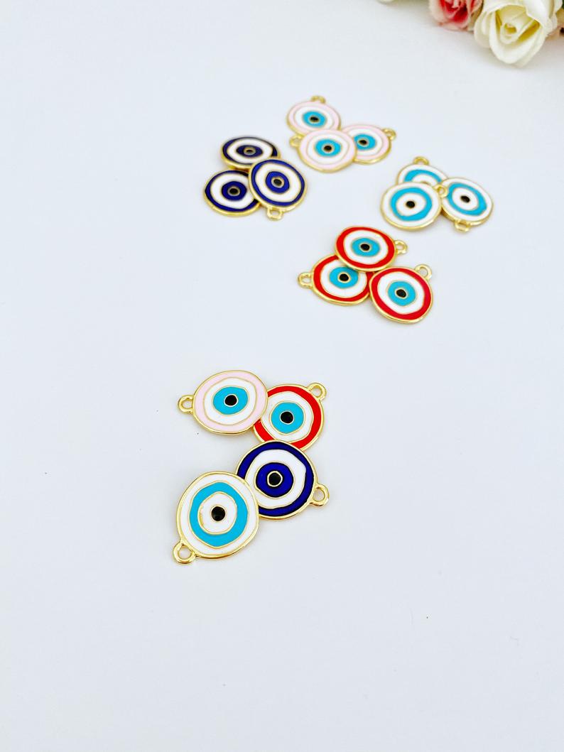 A detailed view of a brass evil eye charm featuring a vibrant blue design, perfect for DIY jewelry projects.