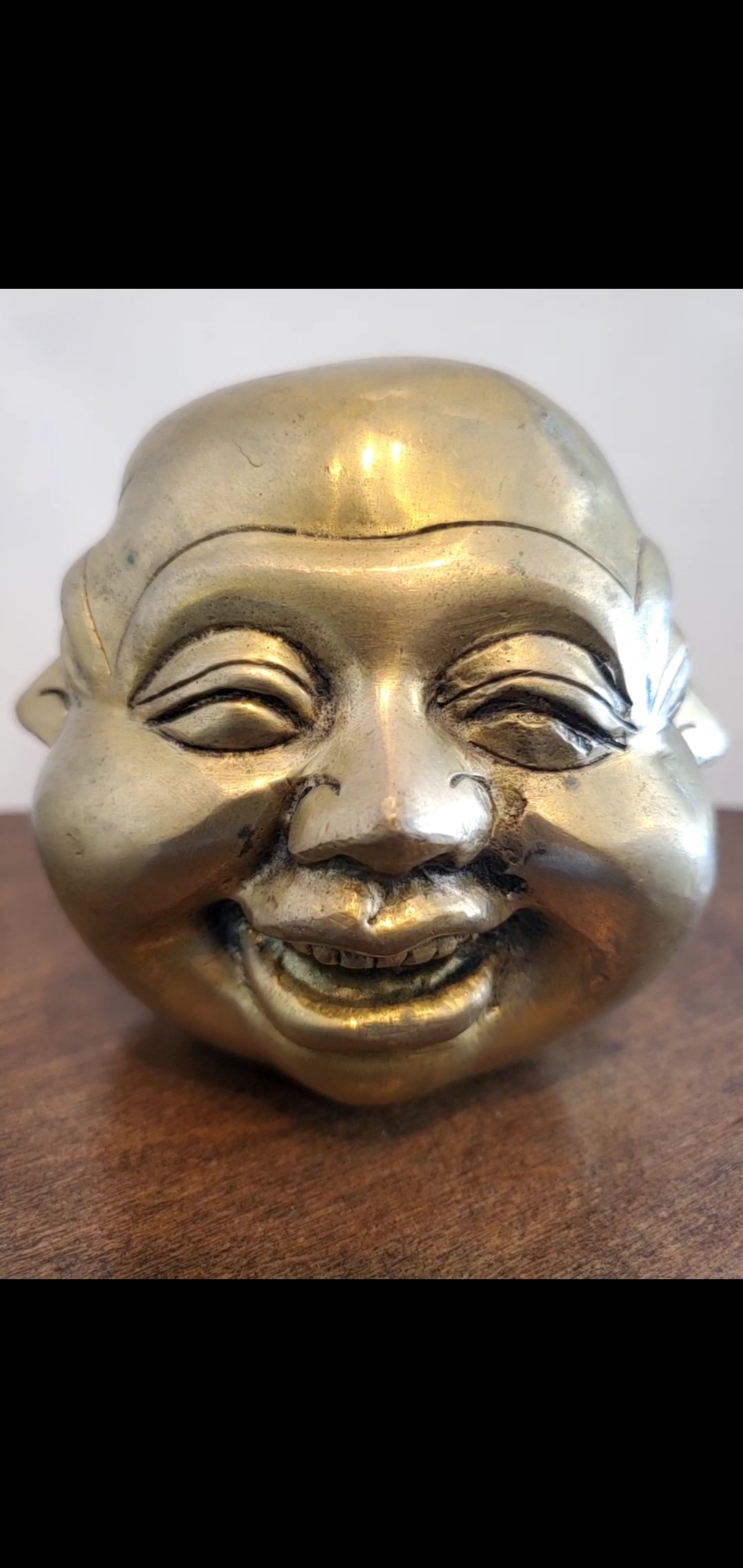 Brass Four Faced Buddha Head Figurine, intricately designed with four faces, symbolizing good fortune and protection.