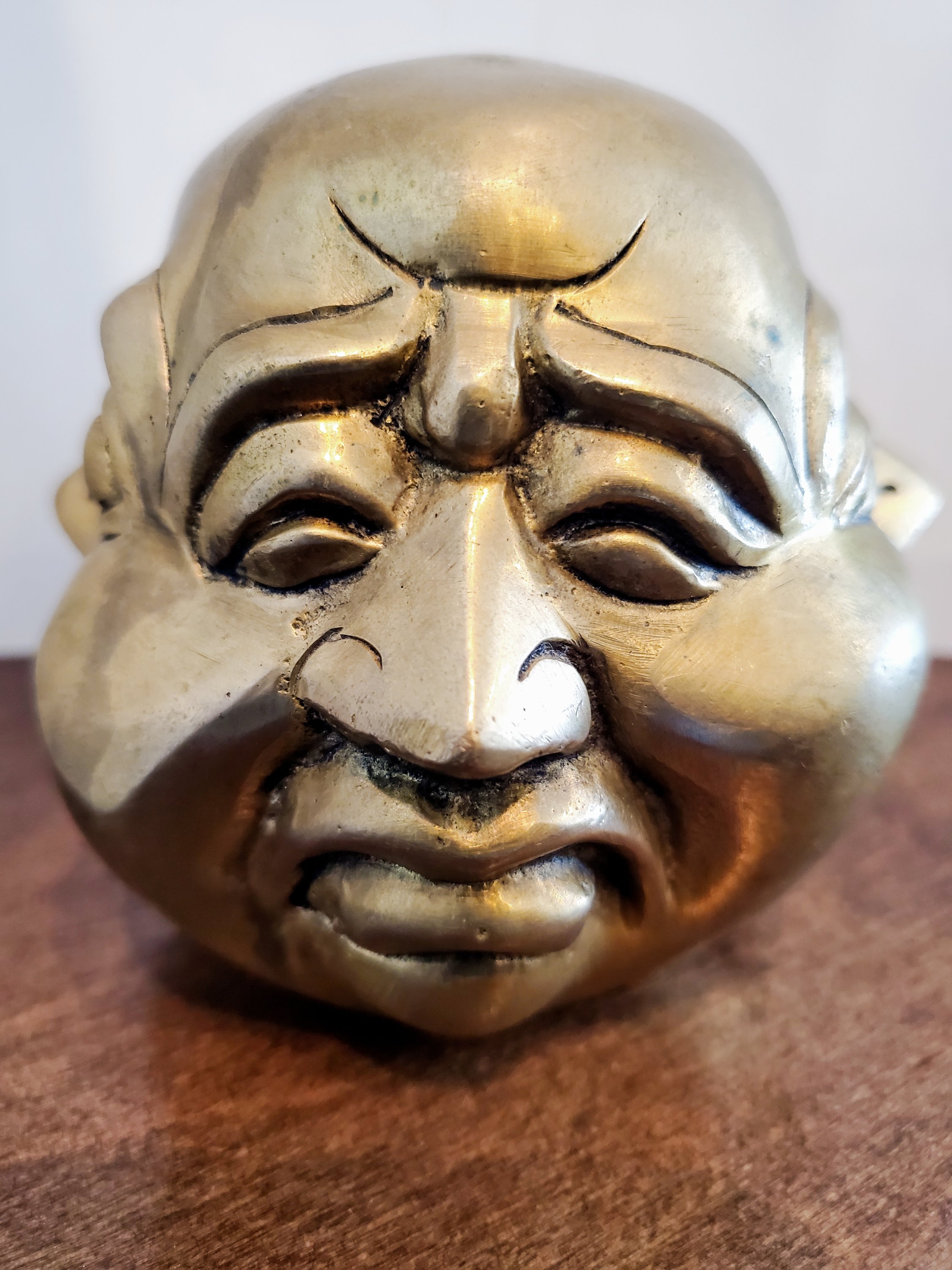 Brass Four Faced Buddha Head Figurine, intricately designed with four faces, symbolizing good fortune and protection.