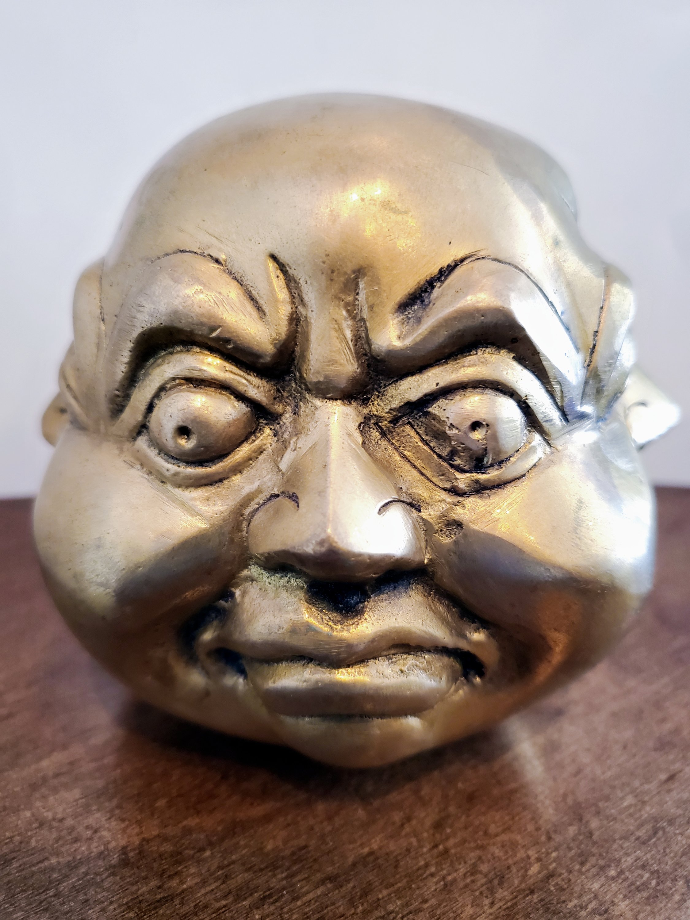 Brass Four Faced Buddha Head Figurine, intricately designed with four faces, symbolizing good fortune and protection.