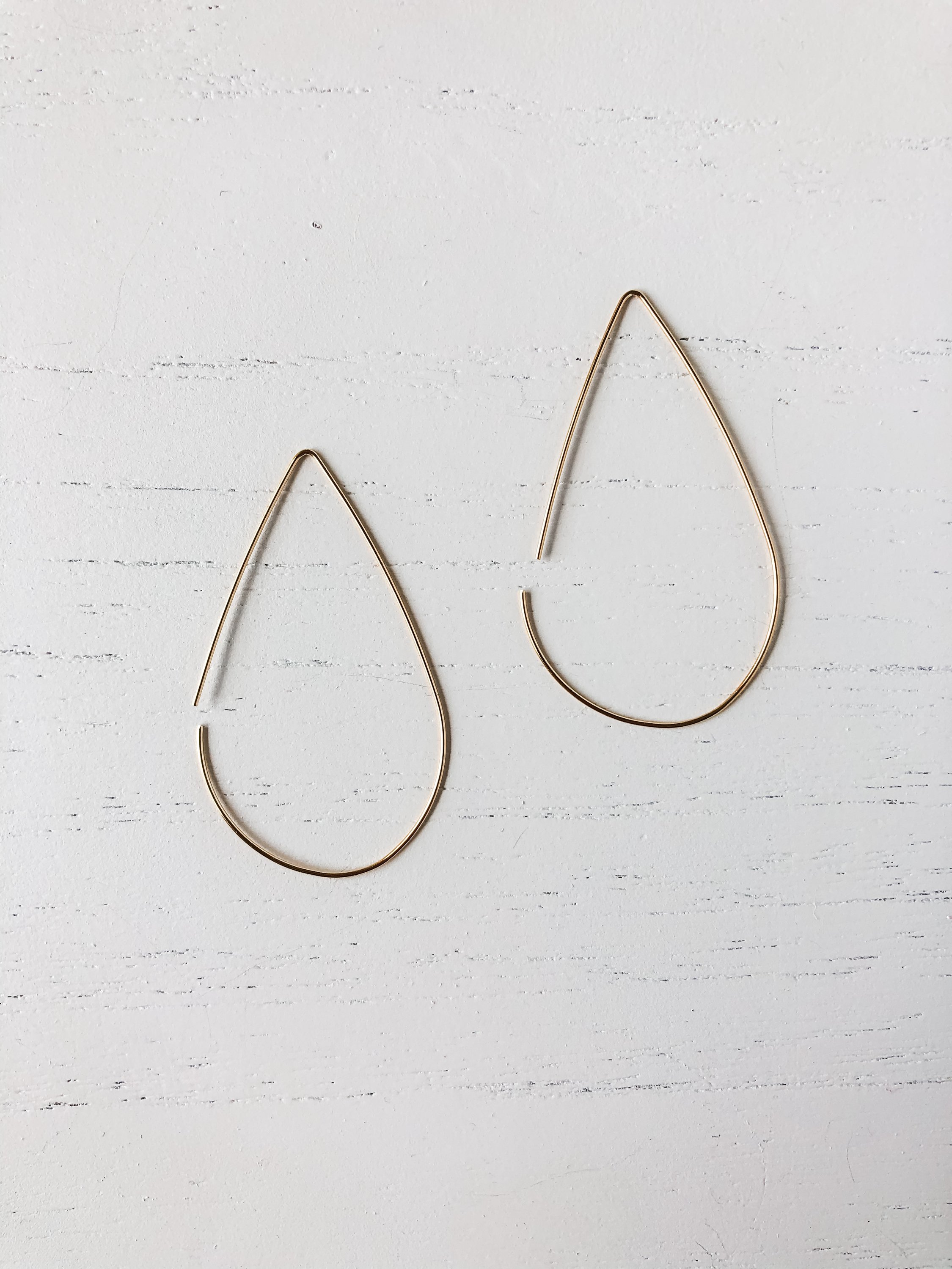 Elegant brass tear drop threader earrings, measuring 1 3/4 inches long, designed for sensitive skin.