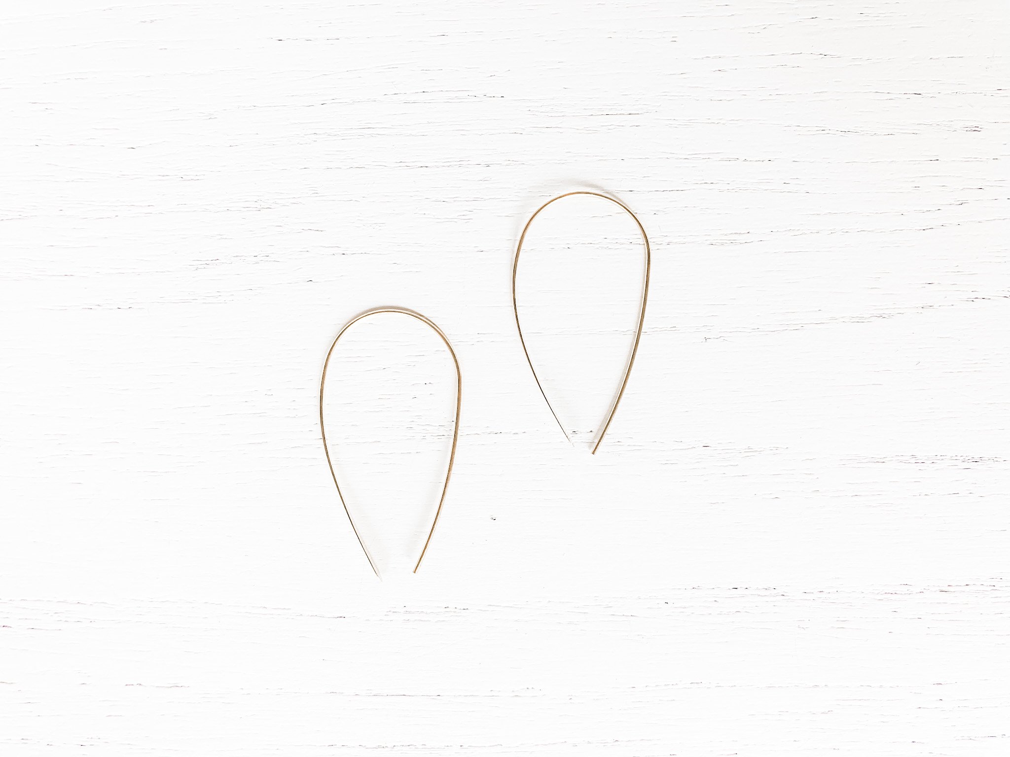 Elegant brass threader earrings measuring 1 3/4 inches, designed for comfort and style.