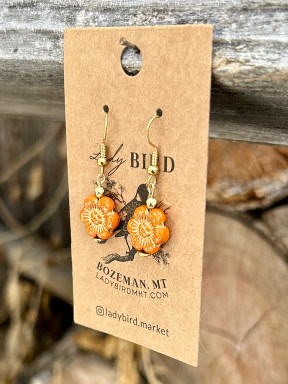 Bright orange Czech glass flower earrings with gold etching, showcasing a wild rose design, perfect for summer fashion.