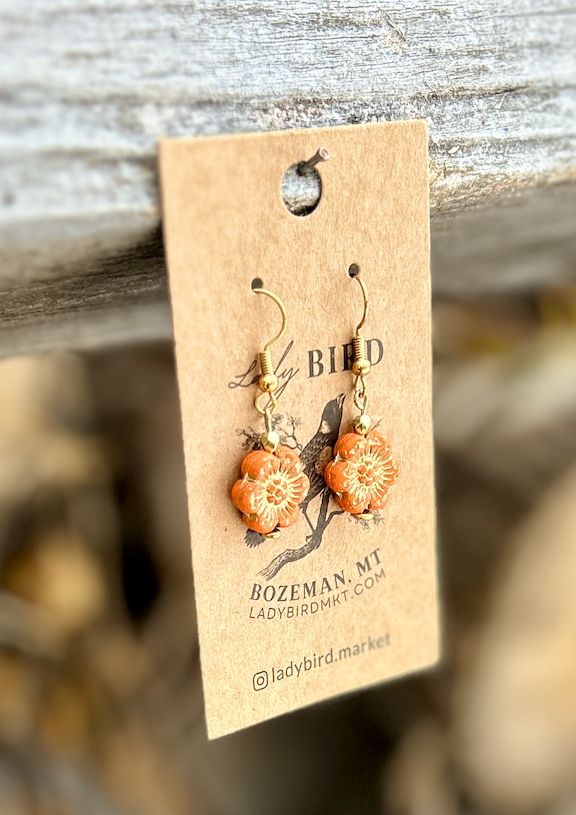 Bright orange Czech glass flower earrings with gold etching, showcasing a wild rose design, perfect for summer fashion.