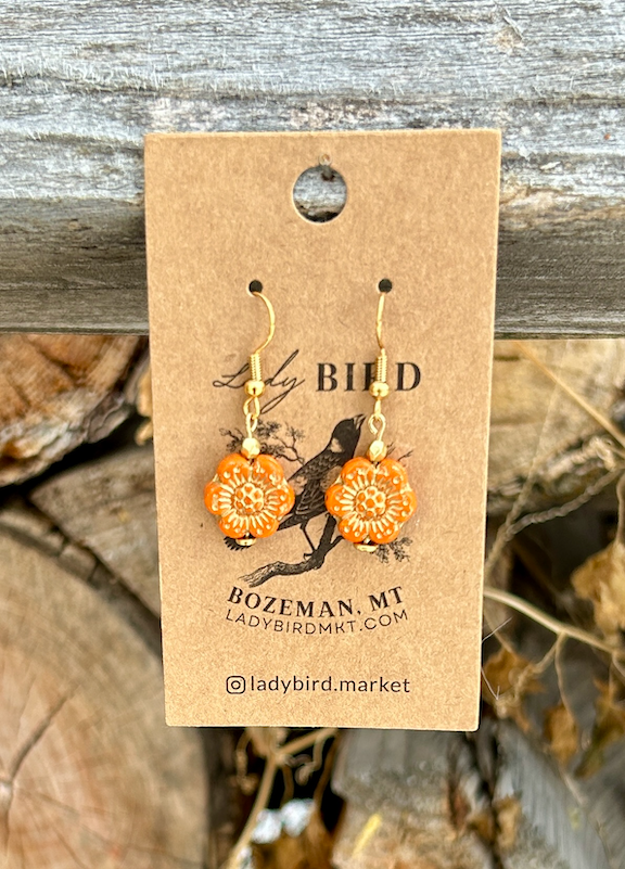 Bright orange Czech glass flower earrings with gold etching, showcasing a wild rose design, perfect for summer fashion.